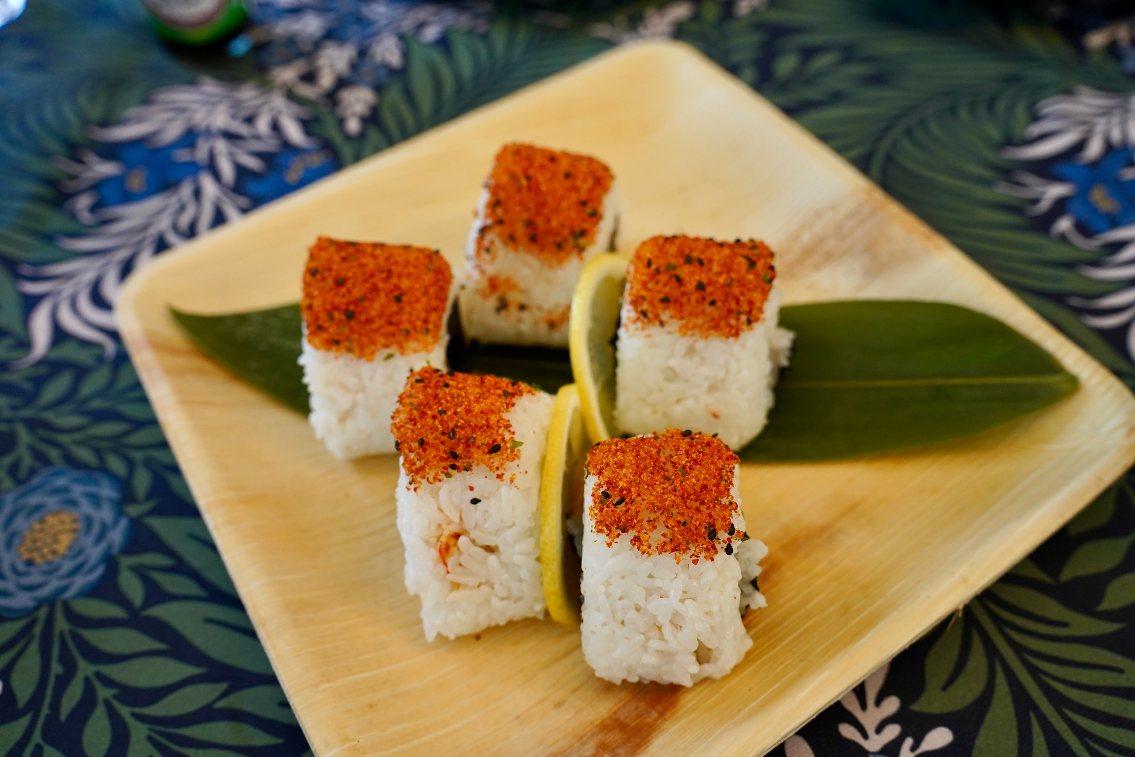 Sushi Boat spicy crab onigiri on bamboo leaf
